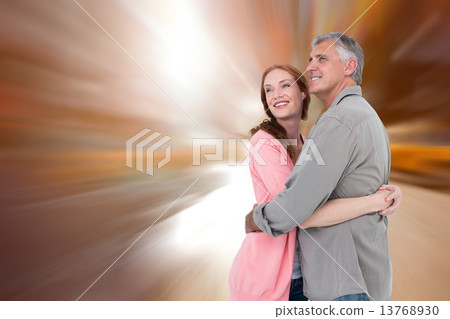 Composite image of casual couple hugging and smiling Composite image of casual couple hugging and smiling 13768930