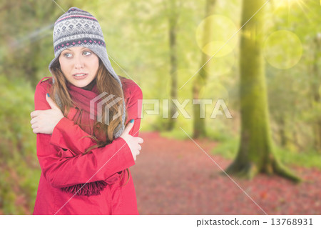 Composite image of cold redhead wearing coat and hat Composite image of cold redhead wearing coat and hat 13768931