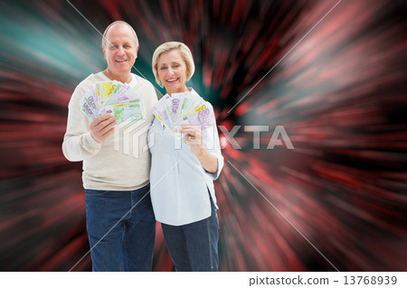 Composite image of happy mature couple smiling at camera showing 13768939