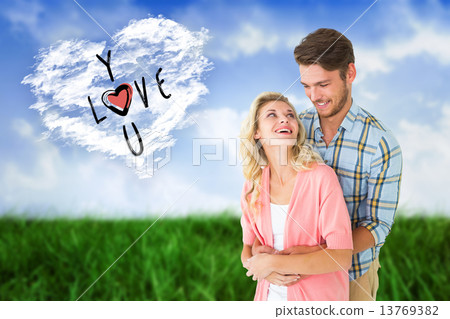 Composite image of attractive young couple embracing and smiling 13769382