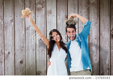 Composite image of happy hipster couple smiling at camera and ch 13769383