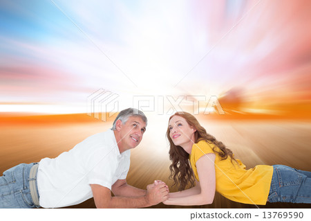 Composite image of casual couple lying and looking up Composite image of casual couple lying and looking up 13769590