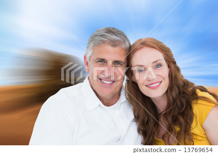 Composite image of casual couple smiling at camera Composite image of casual couple smiling at camera 13769654
