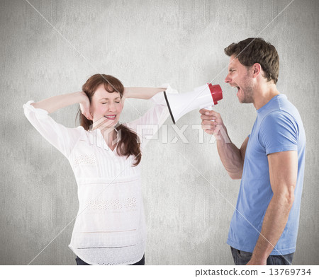 Composite image of man shouting through a megaphone 13769734