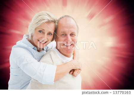 Composite image of happy mature couple smiling at camera 13770163