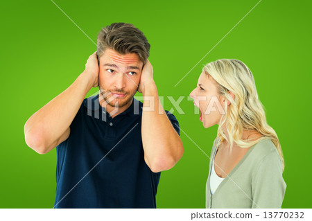 Composite image of man not listening to his shouting girlfriend 13770232