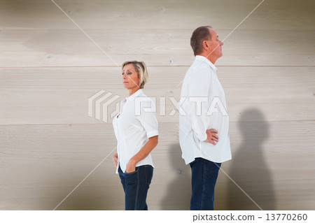Composite image of upset couple not talking to each other after 13770260