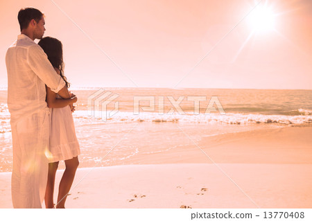 Attractive couple looking out at sea 13770408