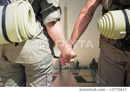 Composite image of hitch hiking couple standing holding hands on Composite image of hitch hiking couple standing holding hands on 13770617