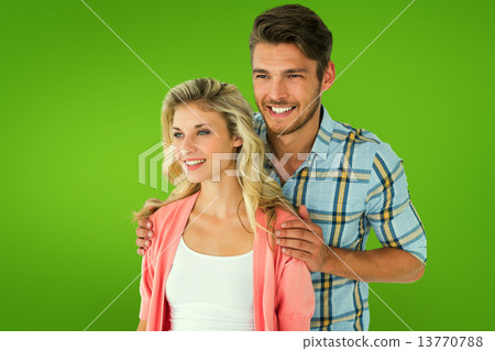 Composite image of attractive young couple smiling together Composite image of attractive young couple smiling together 13770788