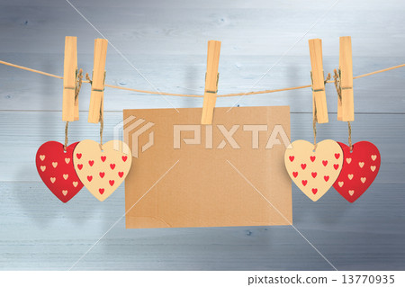 Composite image of hearts hanging on line with card 13770935