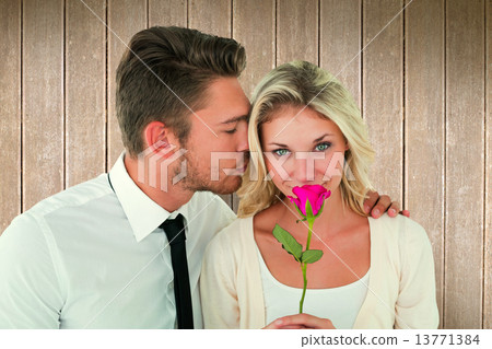 Composite image of handsome man kissing girlfriend on cheek hold 13771384