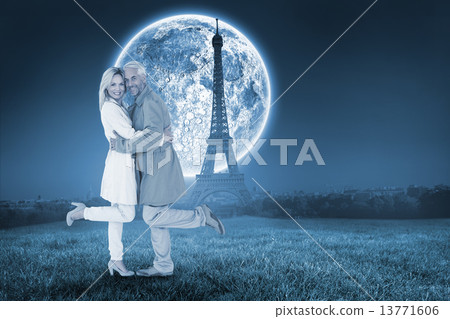Composite image of happy couple posing in trench coats 13771606