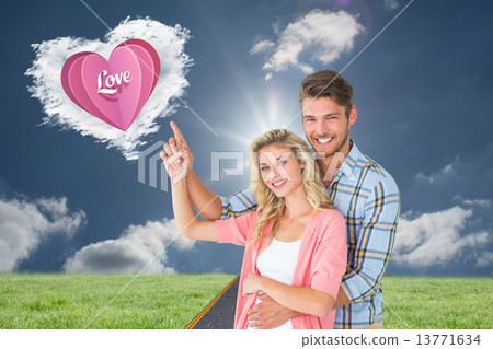 Composite image of attractive young couple embracing and pointin 13771634
