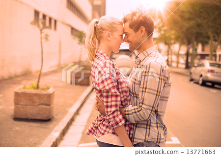 Couple in check shirts and denim hugging each other Couple in check shirts and denim hugging each other 13771663