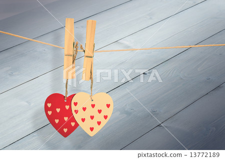 Composite image of hearts hanging on the line Composite image of hearts hanging on the line 13772189
