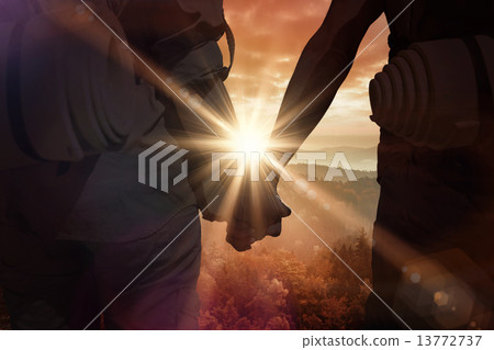 Composite image of hitch hiking couple standing holding hands on 13772737