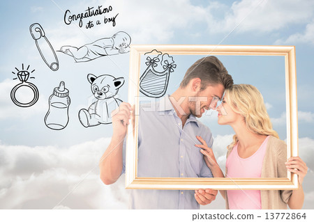 Composite image of attractive young couple holding picture frame 13772864