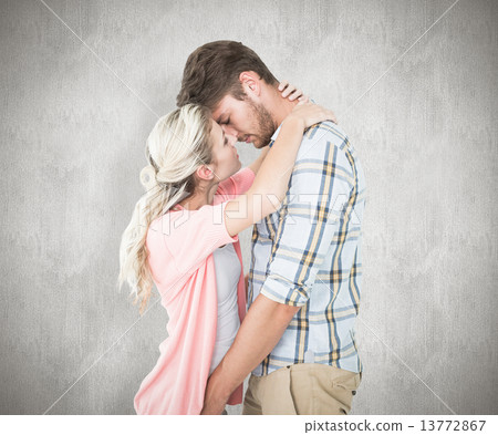 Composite image of attractive young couple about to kiss 13772867