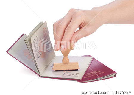 Female hand stamping a passport of Germany Female hand stamping a passport of Germany 13775759