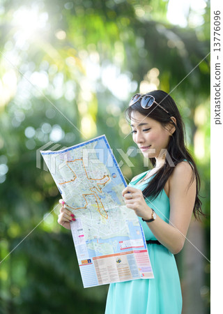 One young Chinese woman having holiday traveling in tropical country 13776096