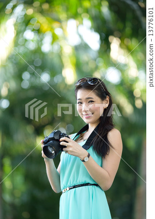 One young Chinese woman taking picture with DSLR One young Chinese woman taking picture with DSLR 13776101