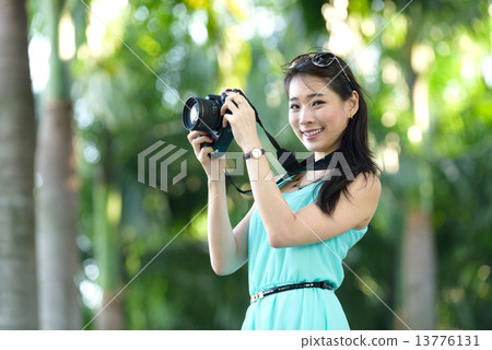 One young Chinese woman taking picture with DSLR One young Chinese woman taking picture with DSLR 13776131
