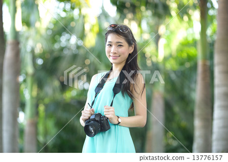One young Chinese woman taking picture with DSLR One young Chinese woman taking picture with DSLR 13776157