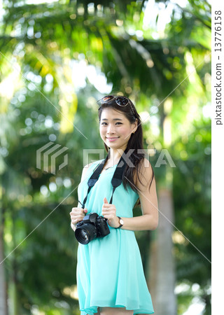 One young Chinese woman taking picture with DSLR One young Chinese woman taking picture with DSLR 13776158
