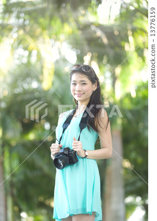 One young Chinese woman taking picture with DSLR One young Chinese woman taking picture with DSLR 13776159