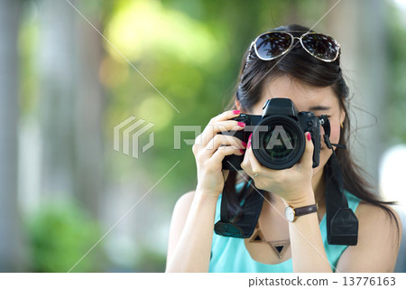 One young Chinese woman taking picture with DSLR One young Chinese woman taking picture with DSLR 13776163