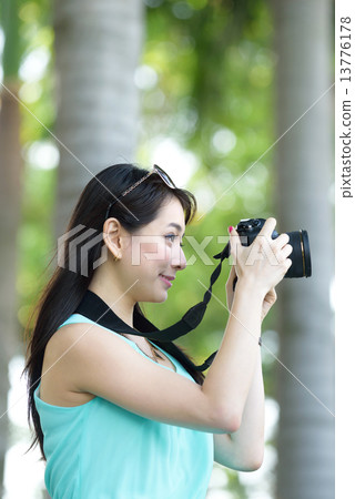 One young Chinese woman taking picture with DSLR One young Chinese woman taking picture with DSLR 13776178