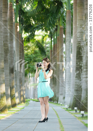 One young Chinese woman taking picture with DSLR One young Chinese woman taking picture with DSLR 13776208