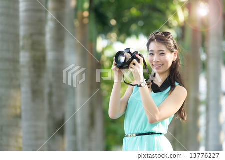 One young Chinese woman taking picture with DSLR One young Chinese woman taking picture with DSLR 13776227