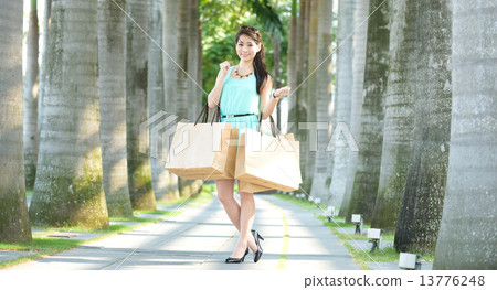 One young chinese woman shopaholic along promenade One young chinese woman shopaholic along promenade 13776248
