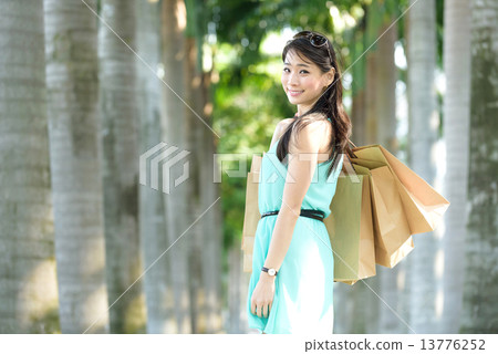 One young chinese woman shopaholic along promenade One young chinese woman shopaholic along promenade 13776252