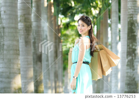 One young chinese woman shopaholic along promenade One young chinese woman shopaholic along promenade 13776253