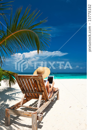 Young woman with tablet pc at the beach Young woman with tablet pc at the beach 13778182
