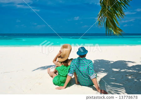 Couple in green on a beach at Maldives Couple in green on a beach at Maldives 13778678