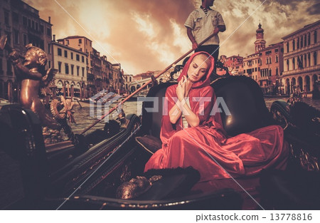 Beautiful woman in red cloak riding on gondola Beautiful woman in red cloak riding on gondola 13778816