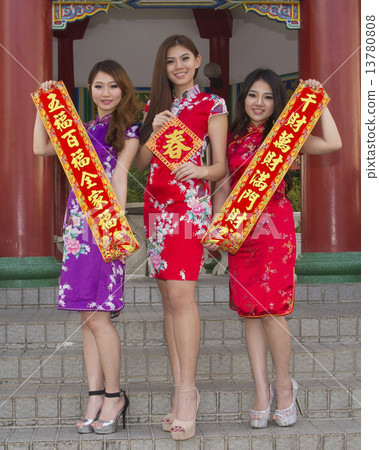 Three girls with CNY greeting things, 13780808