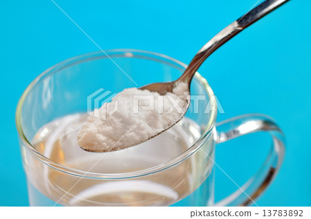 Spoon of baking soda over glass of water Spoon of baking soda over glass of water 13783892