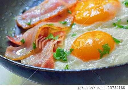 fried egg with bacon in a frying pan 13784188