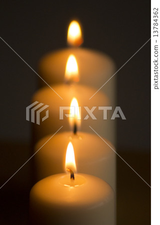Candles lights burning close-up plain background 13784362