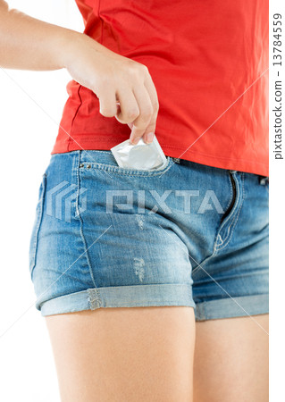 woman in shorts taking out packed condom 13784559