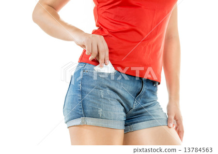 sexy woman putting condom in jeans shorts pocket sexy woman putting condom in jeans shorts pocket 13784563