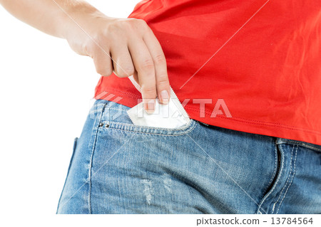 sexy young woman taking condom out of pocket 13784564