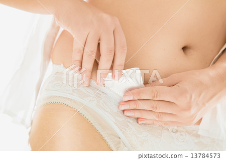 sexy woman putting condom in white lace panties 13784573