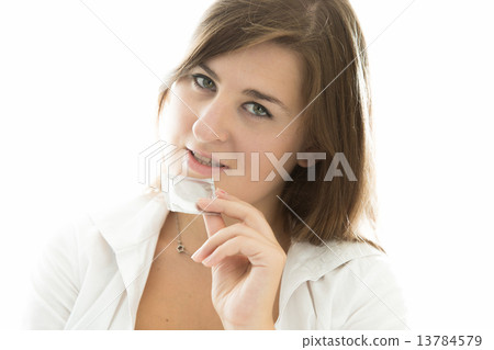 portrait of sexy brunette woman tearing condom by teeth 13784579