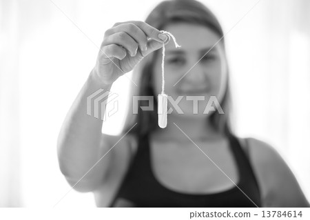 black and white portrait of young cute woman holding menstrual t 13784614